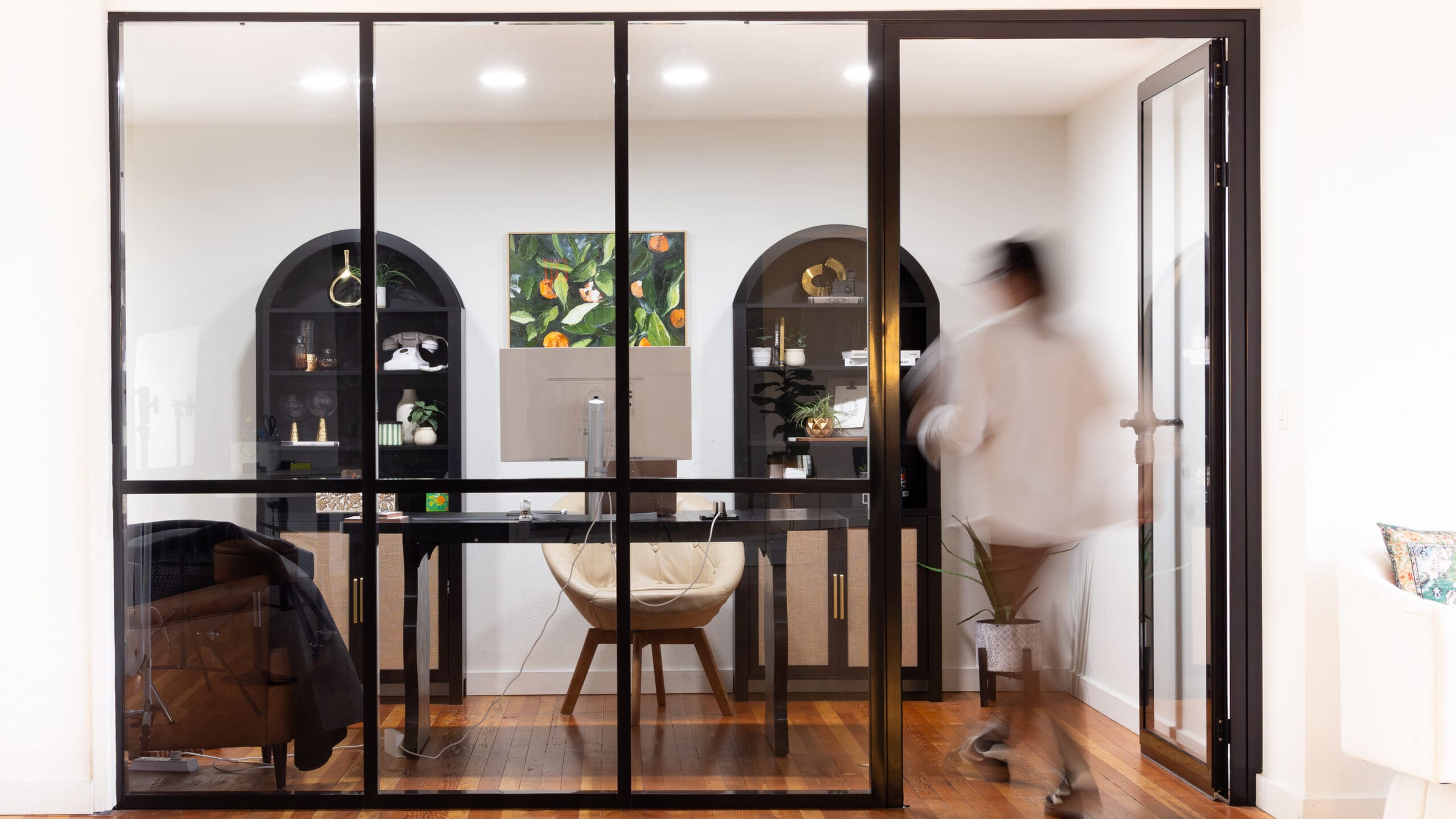 A Velvet Label strategist entering a sun-lit creative studio to develop a 3-step marketing refinement plan for a small business.